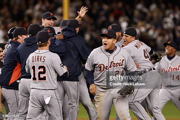 Andy Dirks, Miguel Cabrera, Victor Martinez of the Detroit Tigers and Austin Jackson of the Detroit Tigers celebrate after they won 3-2 against the...