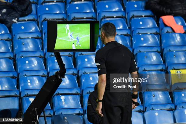 Referee Andre Marriner checks on VAR for a penalty which is later awarded during the Premier League match between Leeds United and Leicester City at...