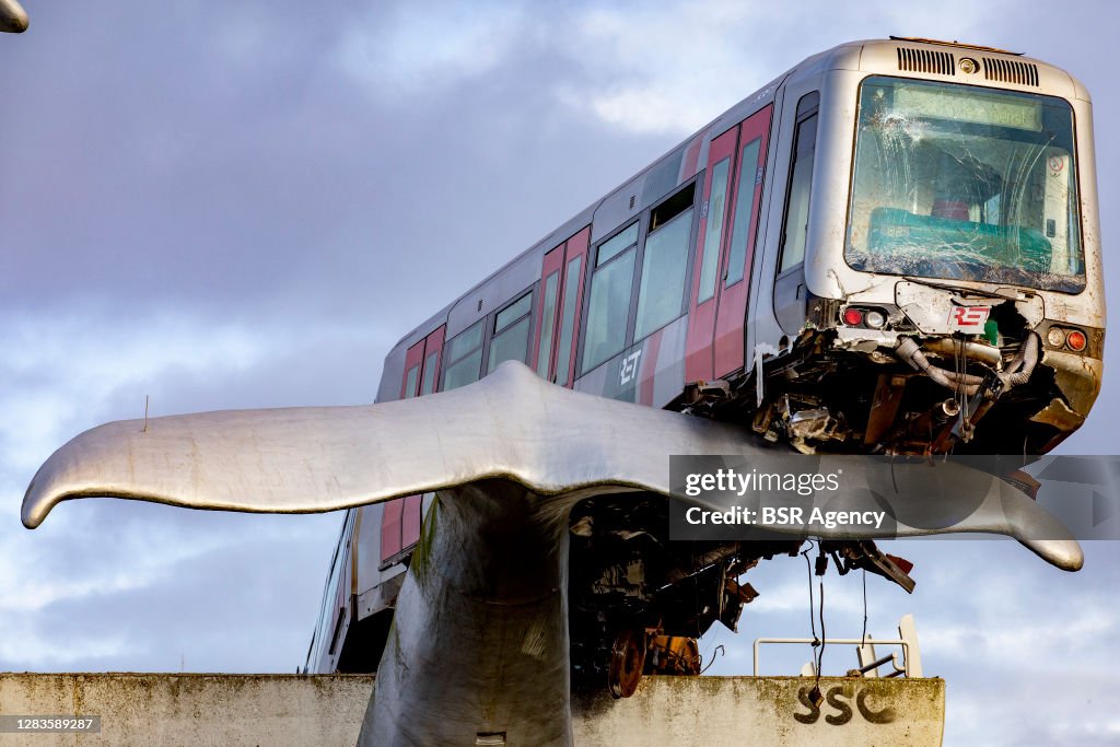 Subway train crashes and balances on whale statue