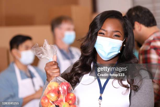 multi-ethnic group of volunteers work at soup kitchen. - social worker mask stock pictures, royalty-free photos & images