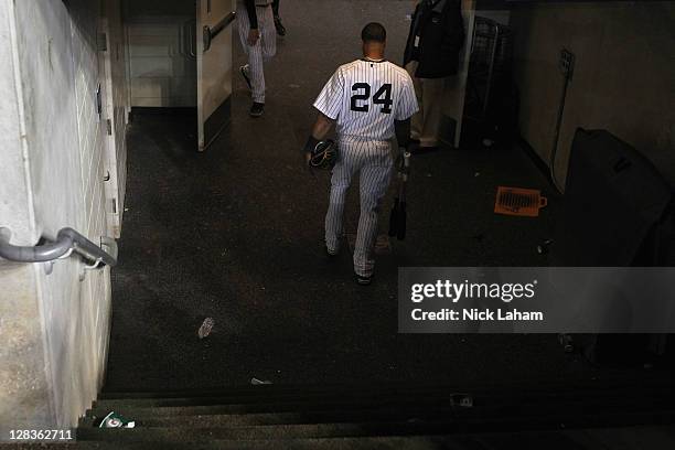 Robinson Cano of the New York Yankees walks out of the dugout dejected towards the locker room after they lost 3-2 against the Detroit Tigers during...