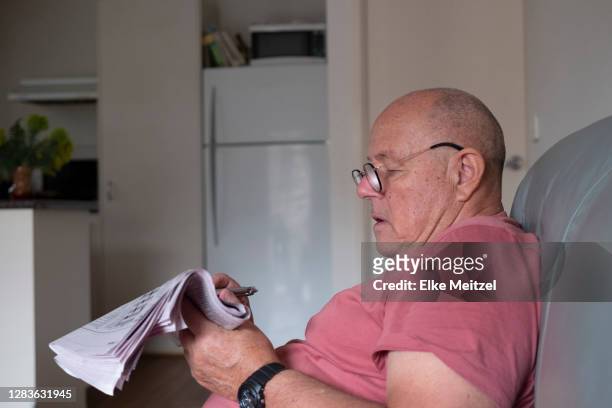 senior with newspaper - melbourne newspaper stock pictures, royalty-free photos & images
