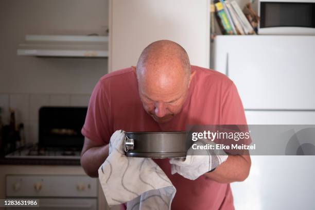 senior looking at cake - baking pan stock pictures, royalty-free photos & images