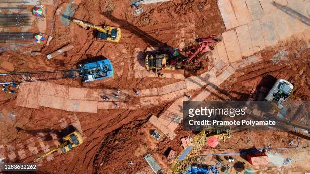 aerial view of excavator heavy machine and mobile crane tower crane with worker in new construction site - civilperson stock pictures, royalty-free photos & images