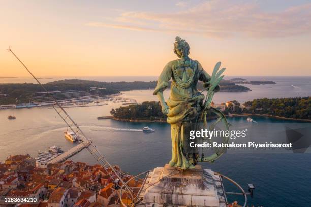 close-up aerial view of statue of saint euphemia (15th century) on top of bell tower in old town rovinj, istria, croatiaj - rovinj stock pictures, royalty-free photos & images