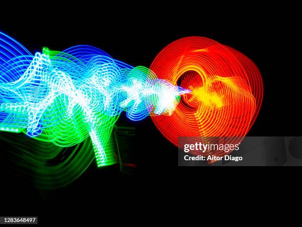 fusion energy in a black background. - nuclear fusion stock-fotos und bilder