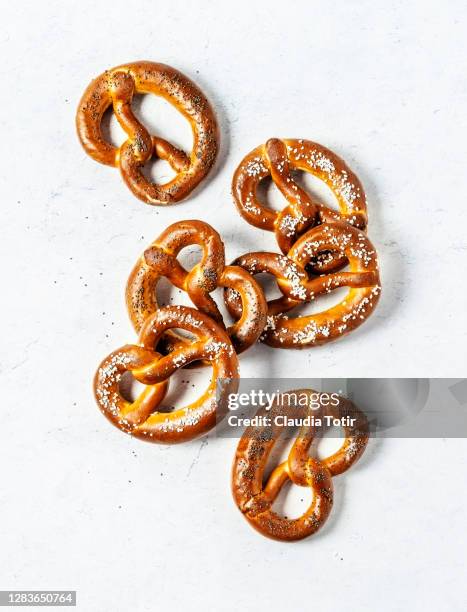 soft pretzels on white background - pretzel stock pictures, royalty-free photos & images