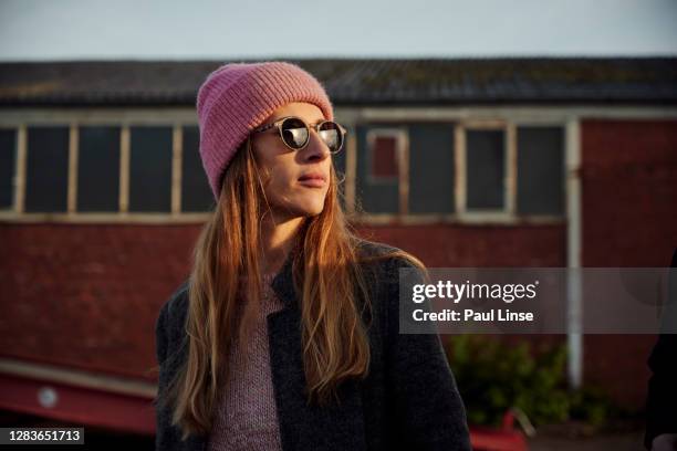 young woman on an autumn morning in an industrial port - osteuropäischer abstammung stock-fotos und bilder