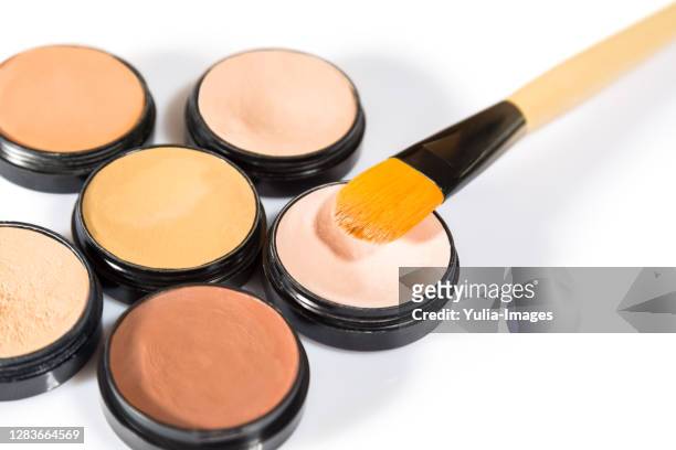 cosmetics with brushes on white background - concealer stock pictures, royalty-free photos & images