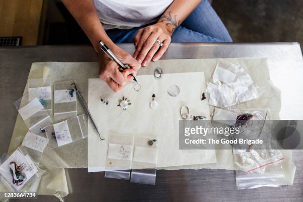 overhead view of jewelry designer at work - jewellery products stock pictures, royalty-free photos & images