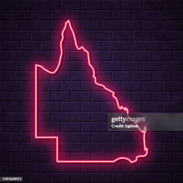 queensland map - glowing neon sign on brick wall background - queensland border stock illustrations