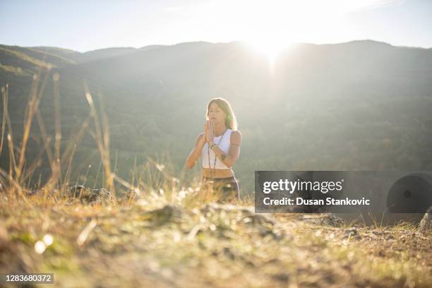 beautiful woman meditating.meditation and zen-like moments in nature. - women in harmony stock pictures, royalty-free photos & images