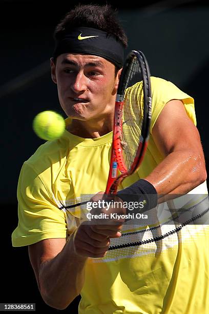 Bernard Tomic of Australia hits a backhand in his quarter final match against Mardy Fish of the United States during day five of the Rakuten Open at...