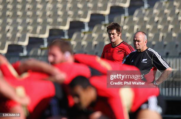 Richie McCaw and coach Graham Henry of the All Blacks watch over the scrum during a New Zealand IRB Rugby World Cup 2011 training session at North...