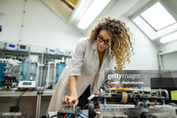 engineer examines the robot - electronics engineering students stock pictures, royalty-free photos & images