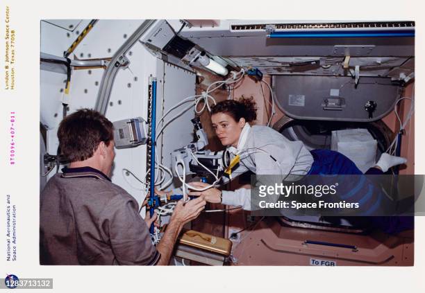 American NASA astronaut Kent Rominger and Canadian CSA astronaut Julie Payette in the US-built Unity node during outfitting of the International...