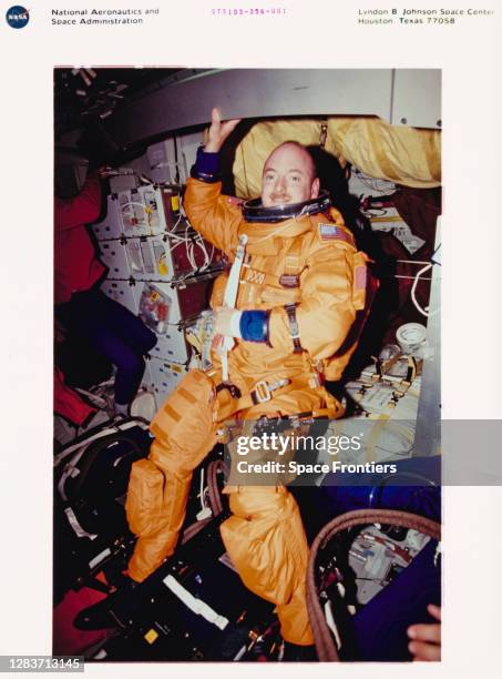 American NASA astronaut Scott J Kelly wearing his partial-pressure ascent and entry escape suit as preparations are made to land the Space Shuttle...