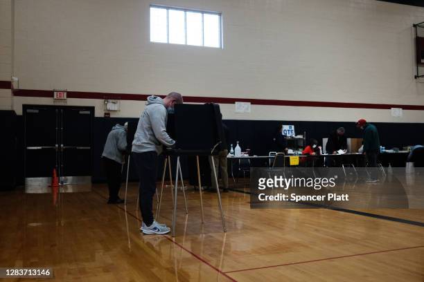 People vote in the presidential election at a polling station on November 03, 2020 in Scranton, Pennsylvania. After a record-breaking early voting...
