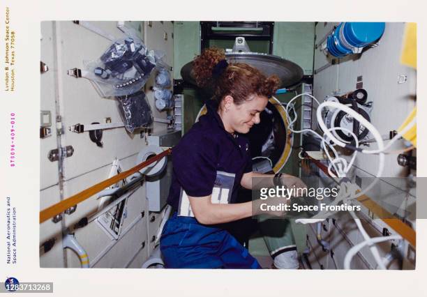 Canadian CSA astronaut Julie Payette works inside the Russian-built Zarya module during the outfitting of the International Space Station , which was...
