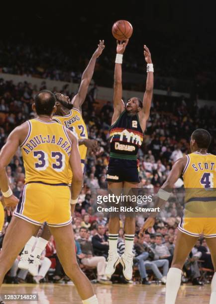 Alex English, Small Forward for the Denver Nuggets jumps to shoot for the basket over the Los Angeles Lakers defense during their NBA Pacific...