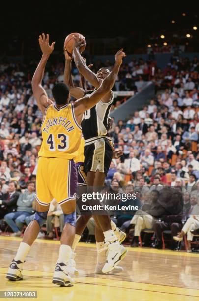 David Robinson, Center for the San Antonio Spurs attempts to pass the basketball as Mychal Thompson of the Los Angeles Lakers attempts to block...