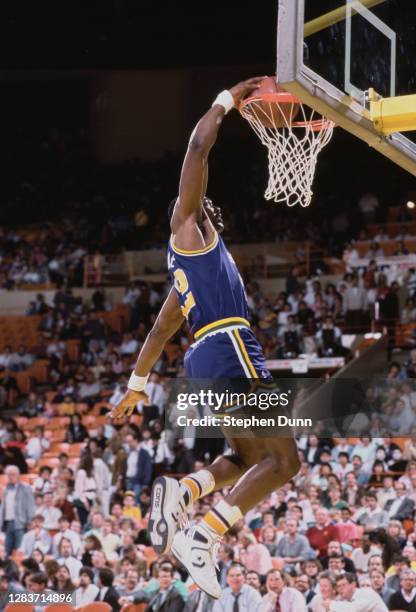 Karl Malone, Power Forward for the Utah Jazz blocks slam dunks the basketball through the hoop during the NBA Pacific Division basketball game...