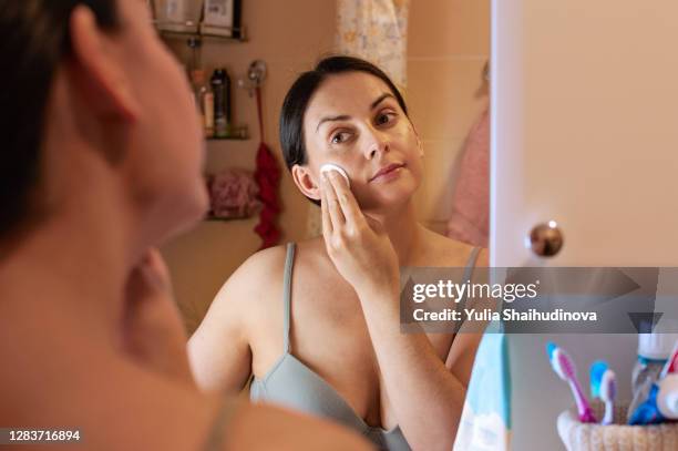 woman is removing make-up with wipe, skin care routine - cotton pad stock pictures, royalty-free photos & images