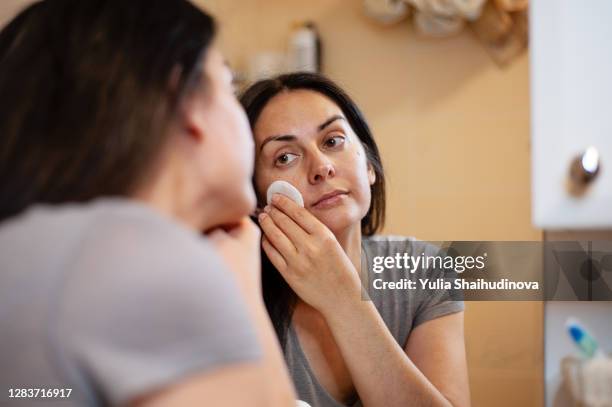 woman is removing make-up with wipe, skin care routine - woman make up face wipes not men stock pictures, royalty-free photos & images