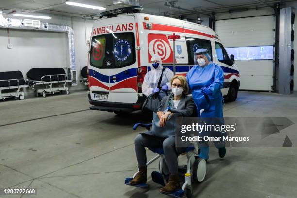 Medical personnel wear protective suits, masks, gloves as they take in a patient who arrived from Warsaw at the SOR of Krakow University Hospital on...