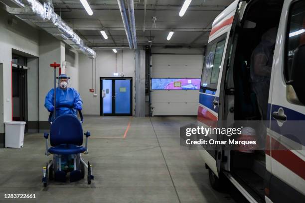Medical personnel wears protective suit, mask and glove as she picks a patient who arrived from Warsaw at the SOR department of Krakow University...