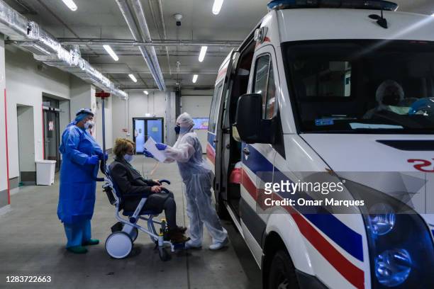 Medical personnel wear protective suits, masks, gloves as they take in a patient who arrived from Warsaw at the SOR of Krakow University Hospital on...