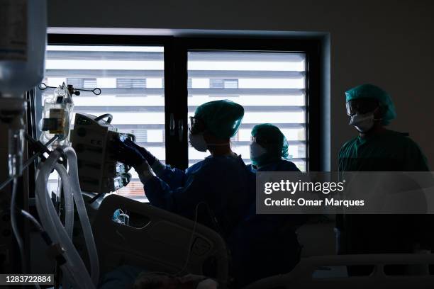 Medical personnel wear protective suits, masks, gloves and face shields during their shift at the ICU of Krakow University Hospital on November 03,...