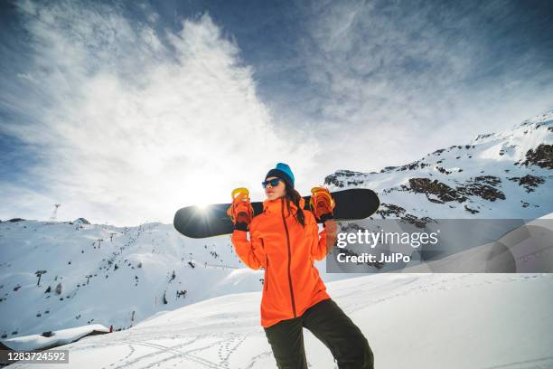 winter holidays in ski resort - woman snowboarding stock pictures, royalty-free photos & images