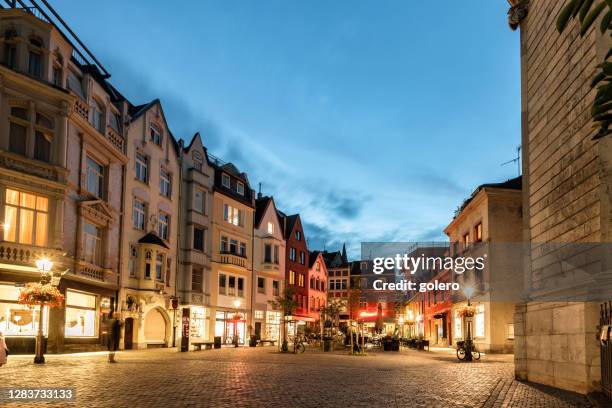 small illuminated town square in the historic center of aachen at blue hour - aachen stock pictures, royalty-free photos & images