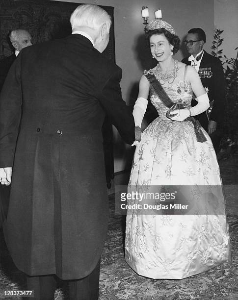 Queen Elizabeth II is greeted by Dr. Theodor Heuss , the President of the Federal Republic of Germany, during her visit to the German Embassy in...