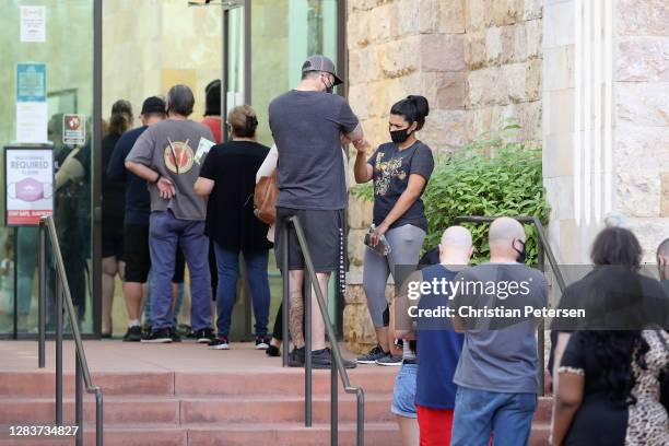 Voters wait in line at the Surprise Court House polling location on November 03, 2020 in Surprise, Arizona. After a record-breaking early voting...