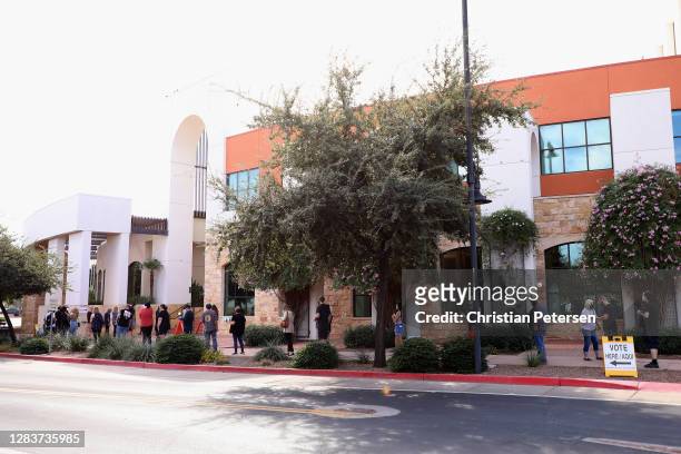 Voters stand in line outside of the Surprise Court House polling location on November 03, 2020 in Surprise, Arizona. After a record-breaking early...