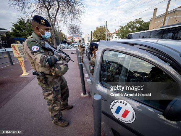 French soldiers, part of France's national security alert system 'Sentinelle', patrol in front of a high school on November 03, 2020 in Marseille,...