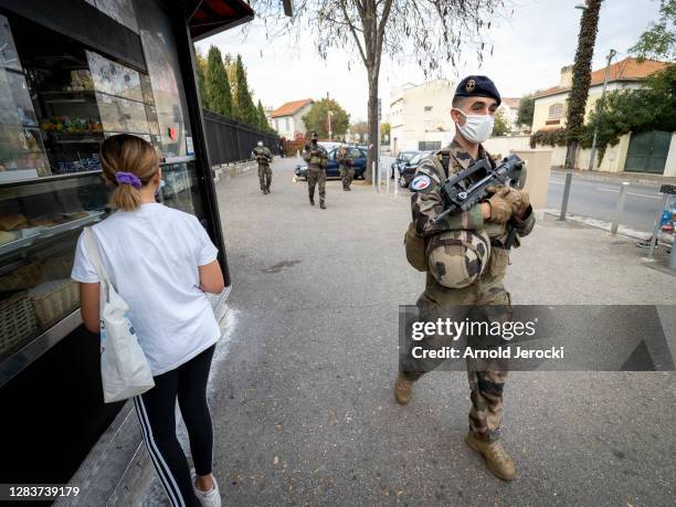 French soldiers, part of France's national security alert system 'Sentinelle', patrol in front of a high school on November 03, 2020 in Marseille,...