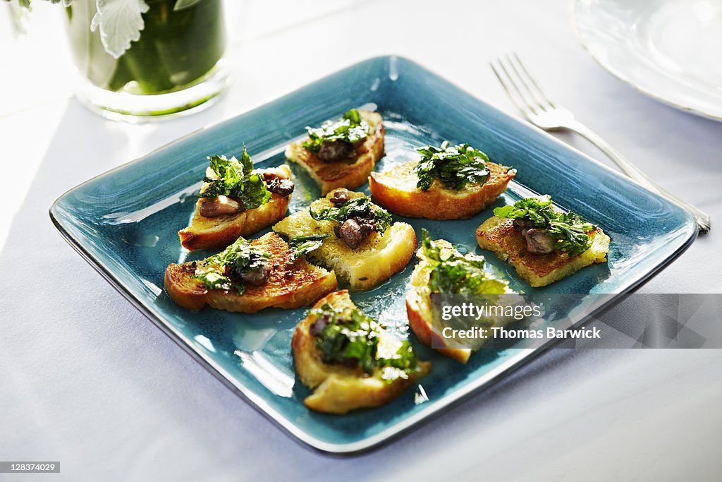 Smoked bone marrow bruschetta with fried parsley