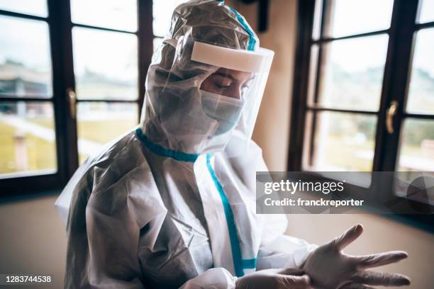 wearing the gloves in a contaminated site - italy coronavirus stock pictures, royalty-free photos & images