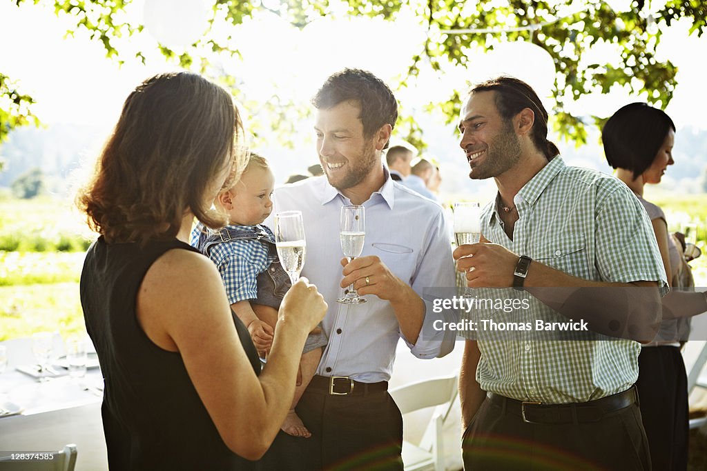 Family standing drinking champagne