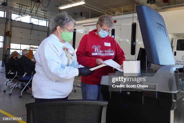 Election officials count absentee ballots at a polling place located in the Town of Beloit fire station on November 03, 2020 near Beloit, Wisconsin....