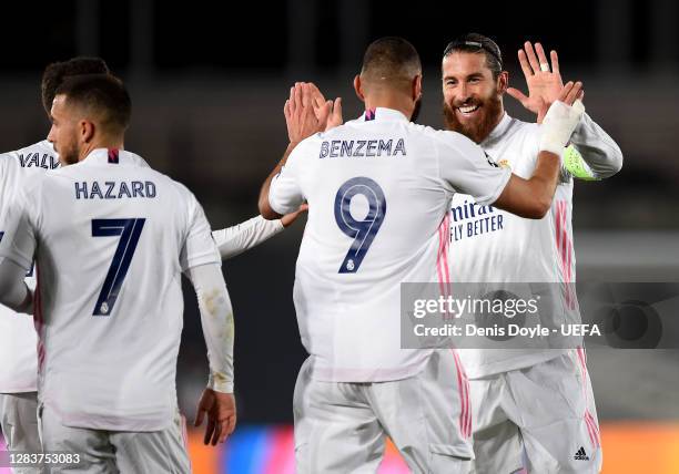Karim Benzema of Real Madrid celebrates after scoring his sides first goal with Sergio Ramos of Real Madrid during the UEFA Champions League Group B...
