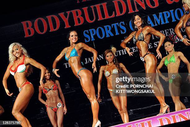 Contestants compete in the first round of the world women model physique over 165 cm. Category at the Asian and World Bodybuilding and Physique Sport...