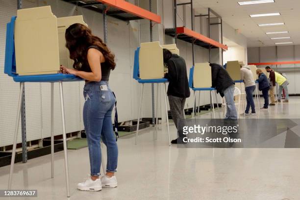 Residents vote at a shuttered Sears store in the Janesville Mall on November 03, 2020 in Janesville, Wisconsin. After a record-breaking early voting...