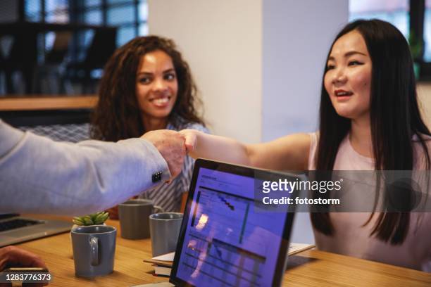 shaking hands in the office is a way of showing respect and kindness - native korean stock pictures, royalty-free photos & images
