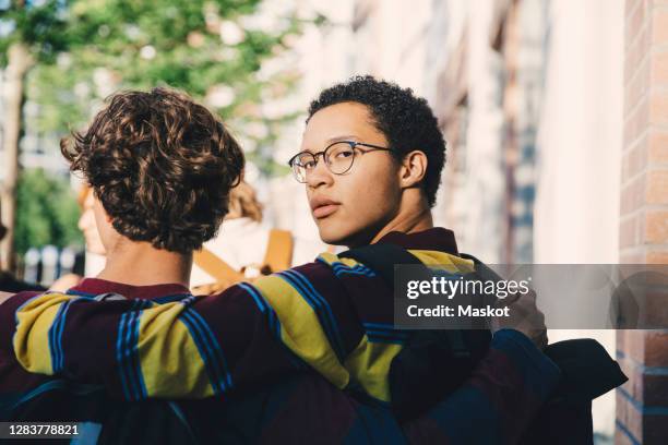 portrait of young man with male friend in city - glases group nature stock pictures, royalty-free photos & images