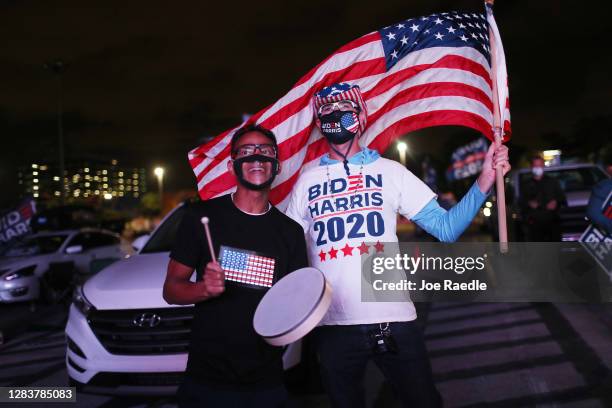 Alex Suarez and Ralph Reichard watch a broadcast of CNN showing presidential election returns at a election night watch party at Mana Wynwood...