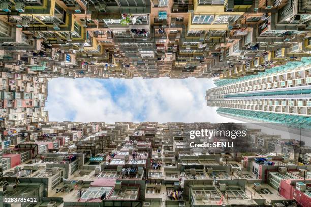 low angle view of the city residential buildings and office buildings with blue sky in quarry bay, hong kong - hong kong residential building stock pictures, royalty-free photos & images